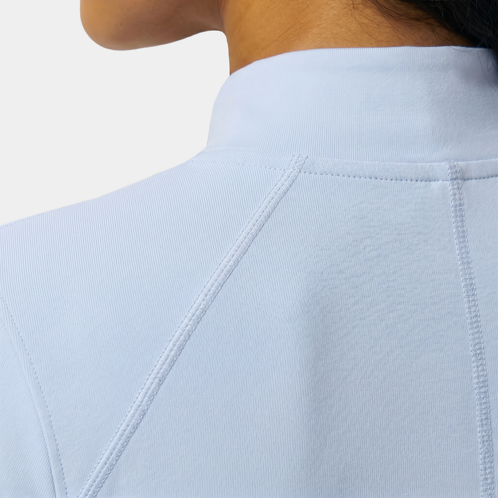 Light blue shirt with a close-up of the collar and shoulder area on a white background